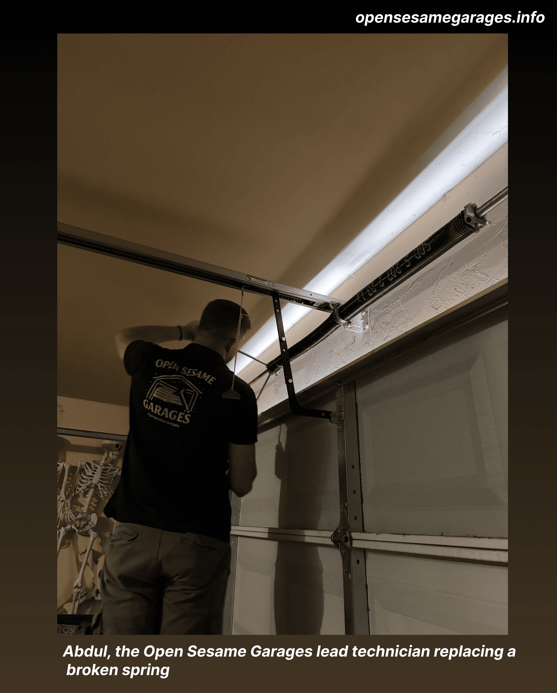 Open Sesame Garages technician working on the spring system on the shaft above a residential garage door in Oklahoma City